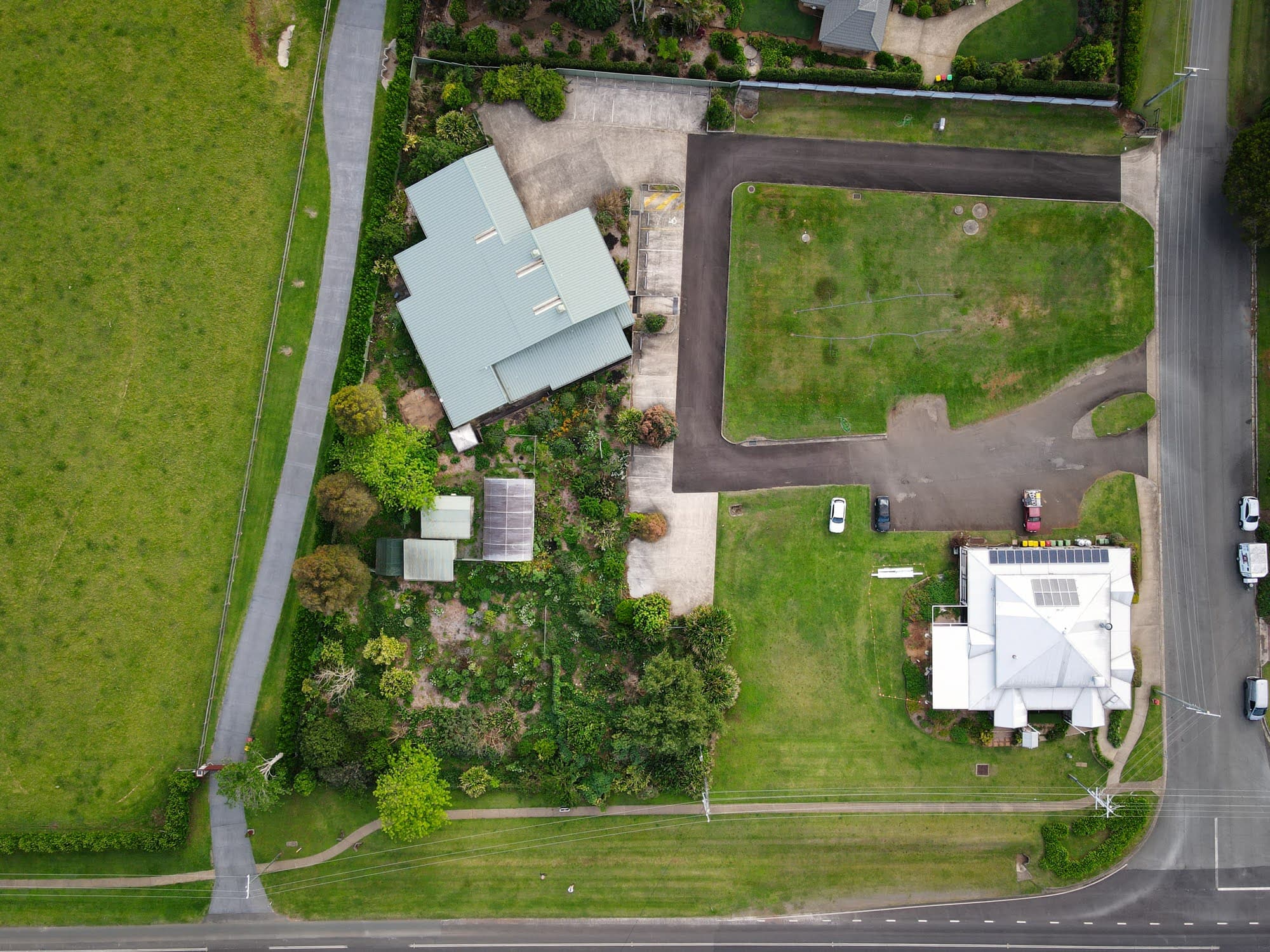 The Harvest at Witta on Jinibara Country, Sunshine Coast hinterland. The former Green Harvest seed house at dusk, surrounded by garden and bushland.