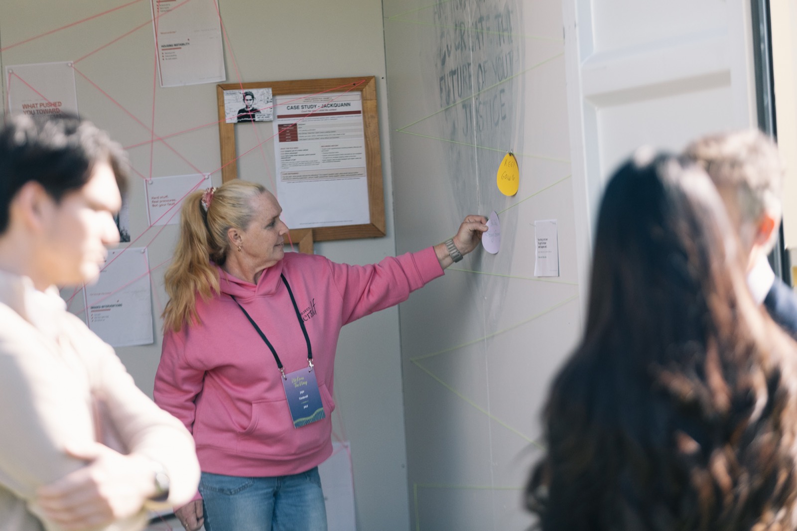 A visitor placing a written reflection inside CONTAINED